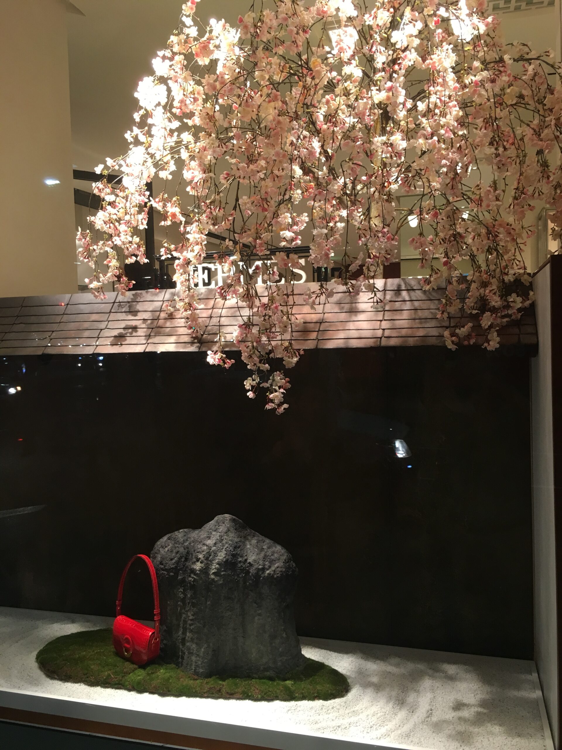 Commercial Oriental garden display with a handbag and feature stone